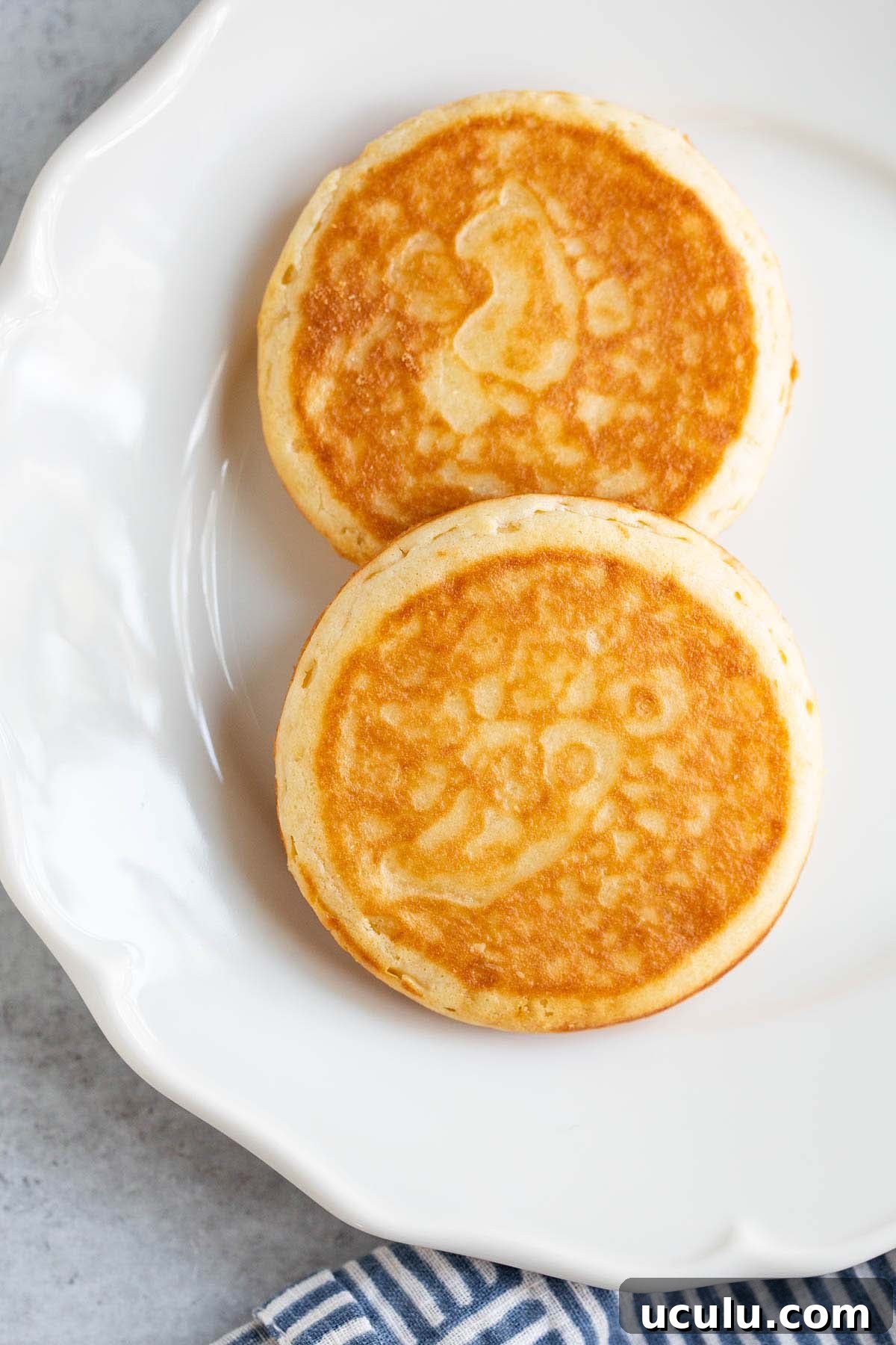 Cooked griddle cakes on a white plate.