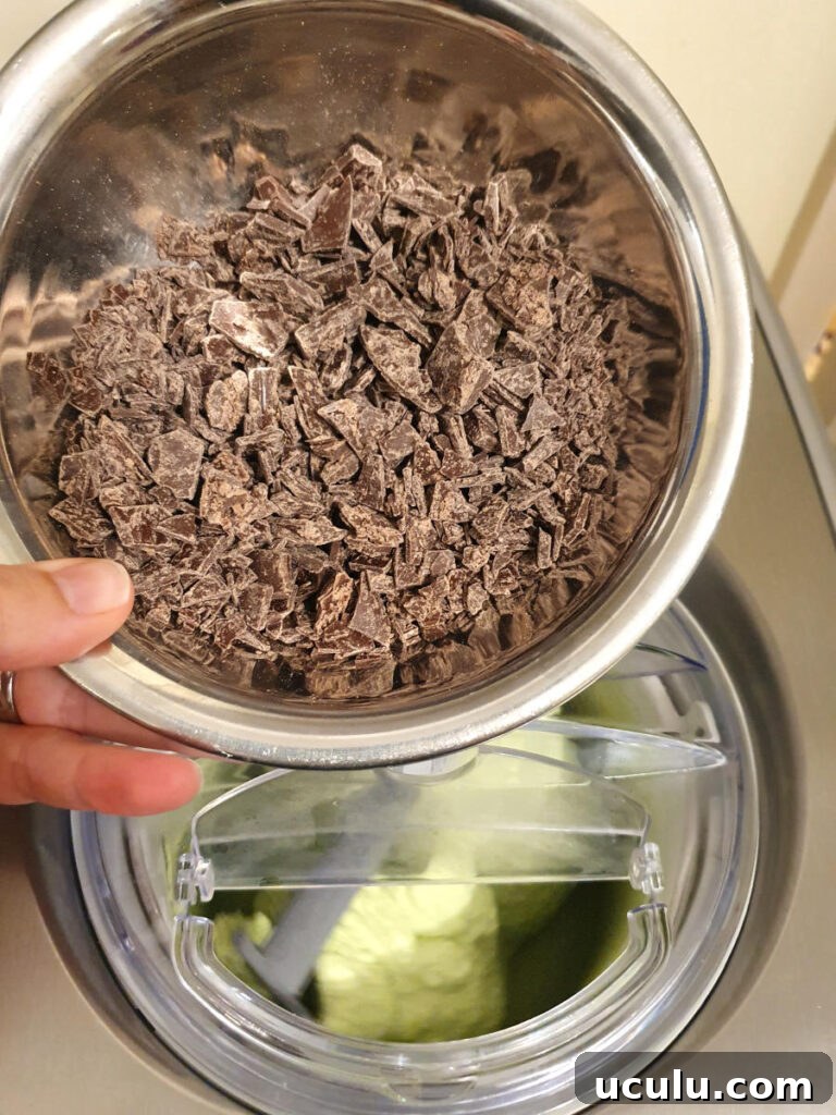 Adding chocolate chips to churning ice cream