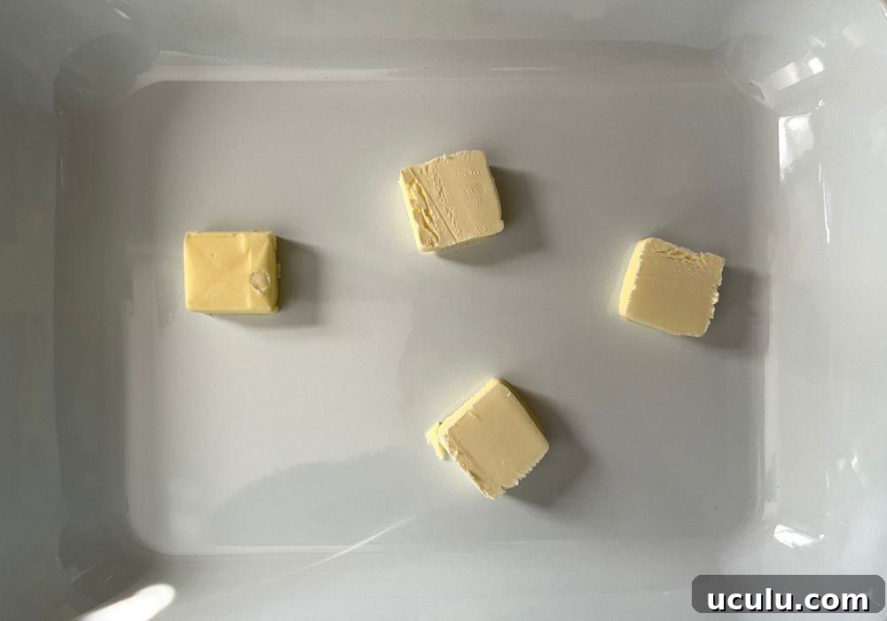 cubes of butter in a baking dish, ready to be melted.