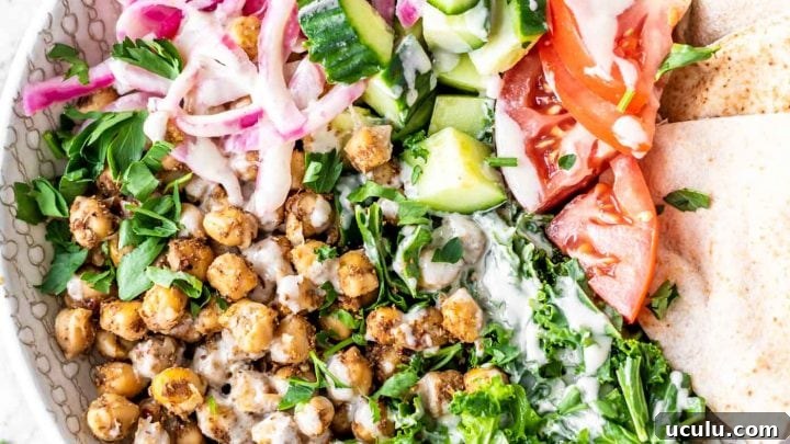 Salad with shawarma chickpeas, kale, parsley, pickled onions, pita and tomato.