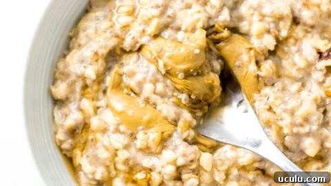 Bowl of banana oatmeal topped with peanut butter.