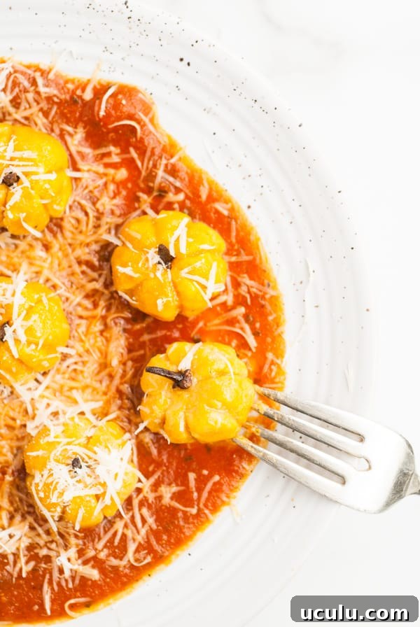 Pumpkin Shaped Gnocchi on a plate with a fork.