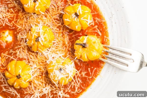 Pumpkin Shaped Gnocchi on a plate sprinkled with cheese.