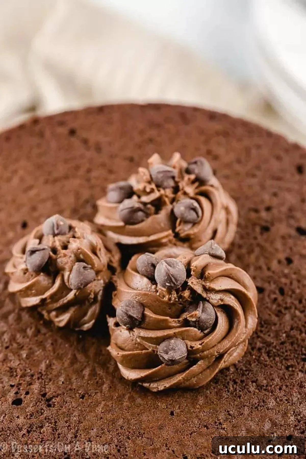 Close up image of chocolate frosting on a cake.