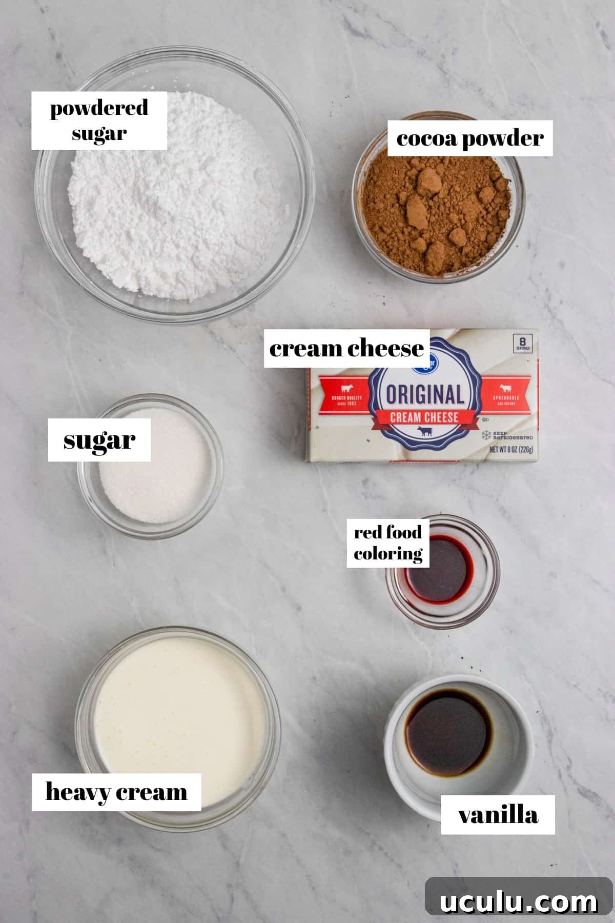 Cream cheese, powdered sugar, cocoa powder and other ingredients labeled on counter.