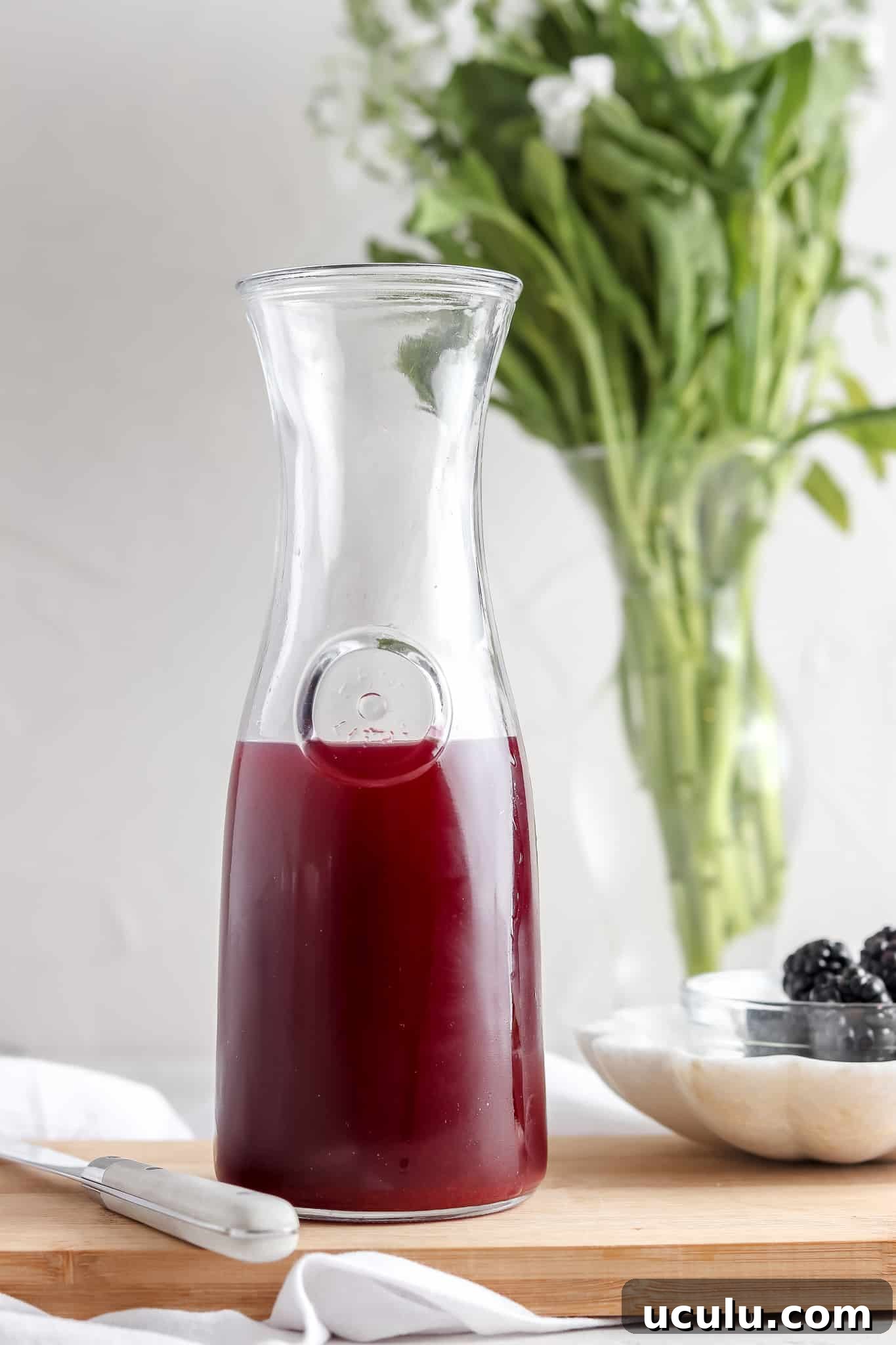 Blackberry simple syrup in a glass jar.