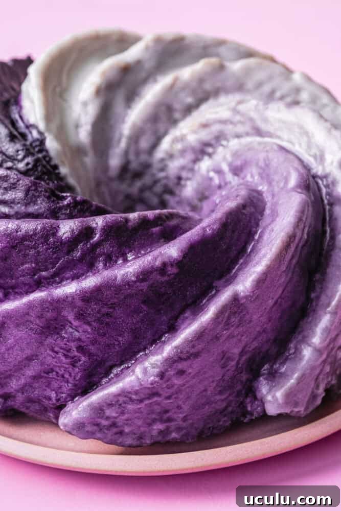 Close-up detail of ube ombré glaze swirls on crème fraîche Bundt cake on pink plate