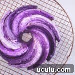 Ube cake — crème fraîche Bundt cake with ombré purple ube glaze on a wire cooling rack, overhead shot