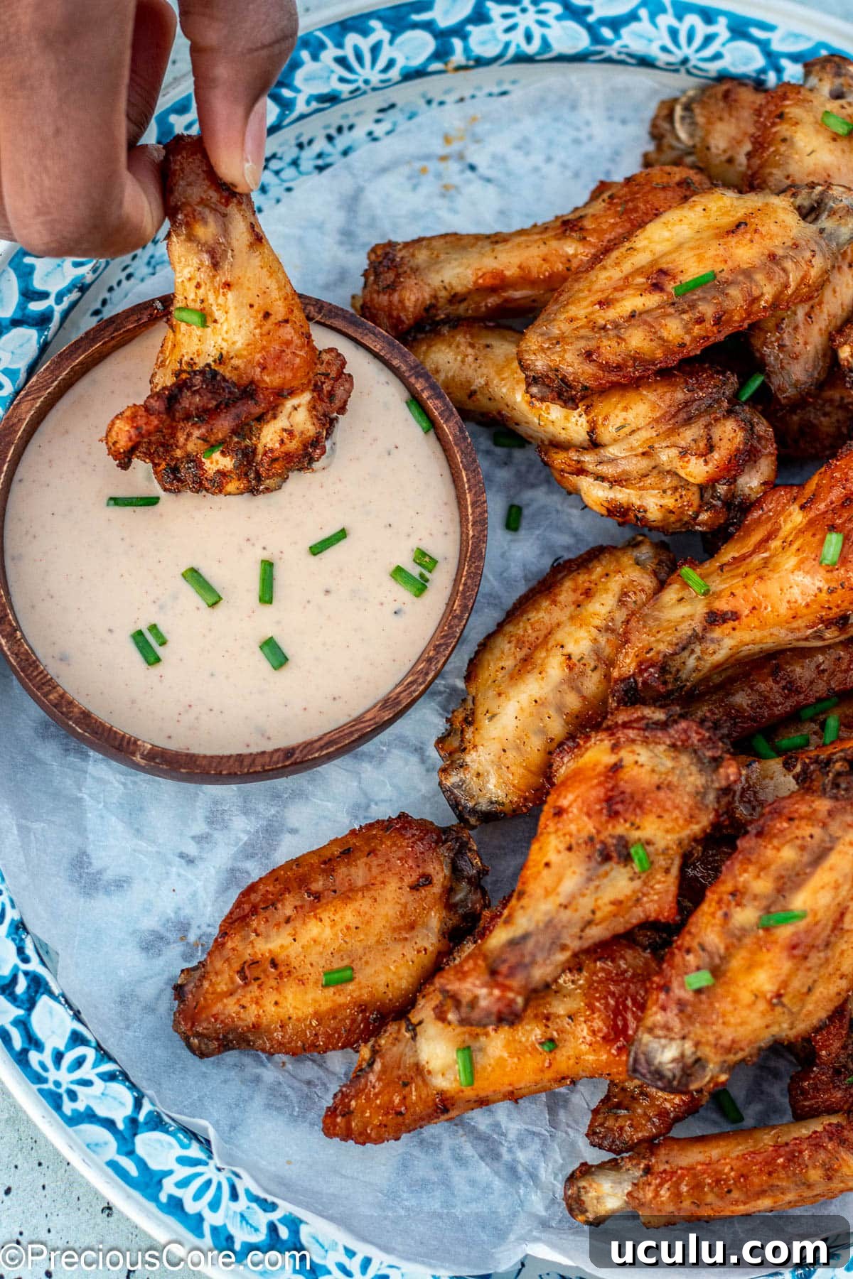 Dipping a wing into ranch.