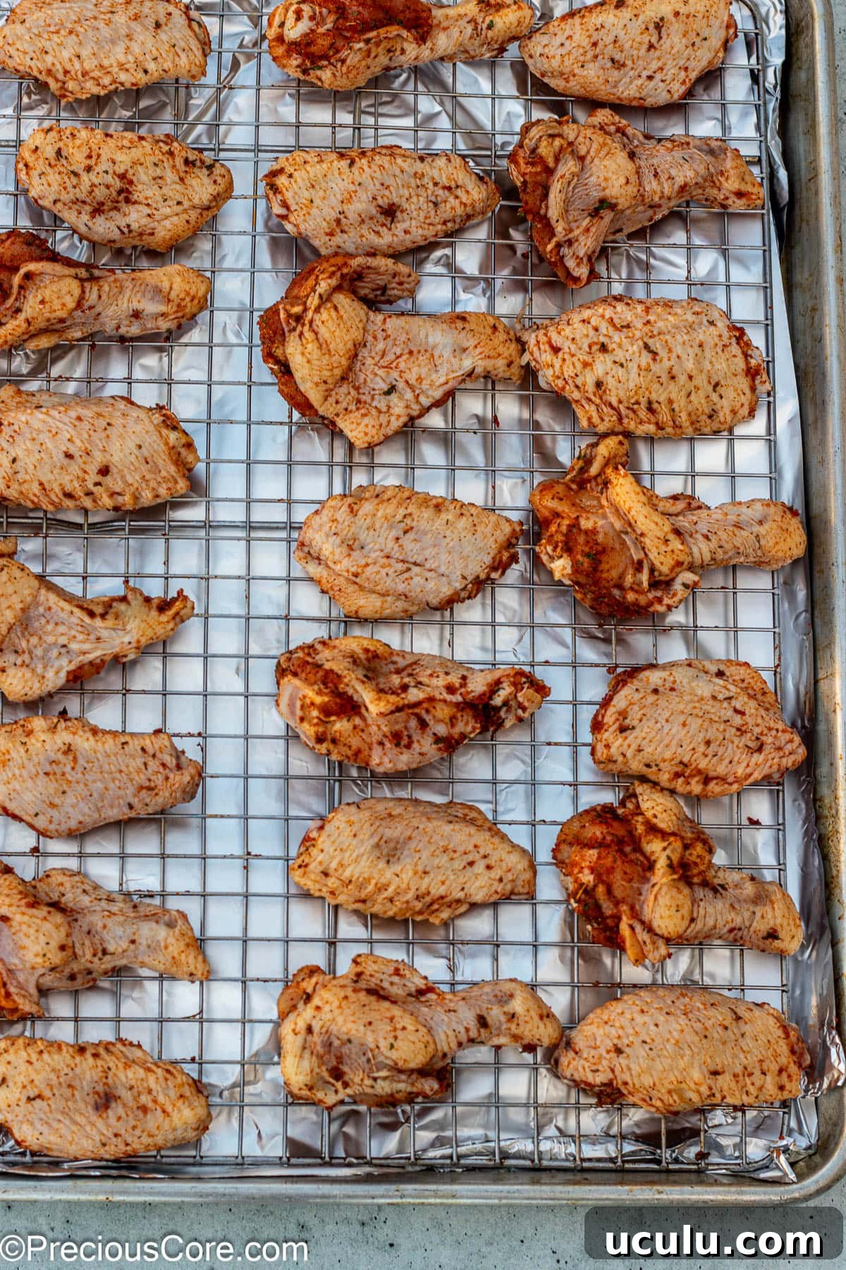 Wings placed on oven-safe baking rack.
