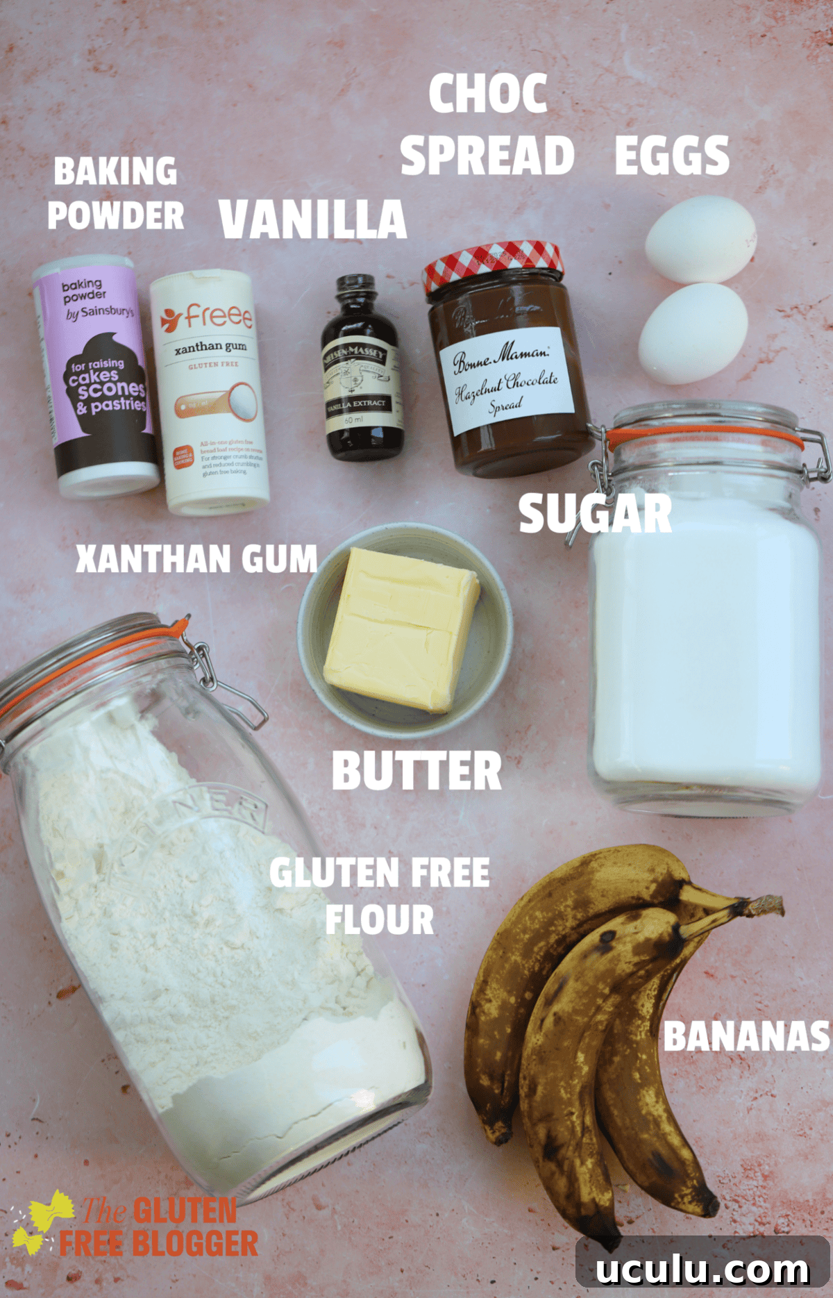 Ingredients for gluten free banana nutella muffins on a pink backdrop.