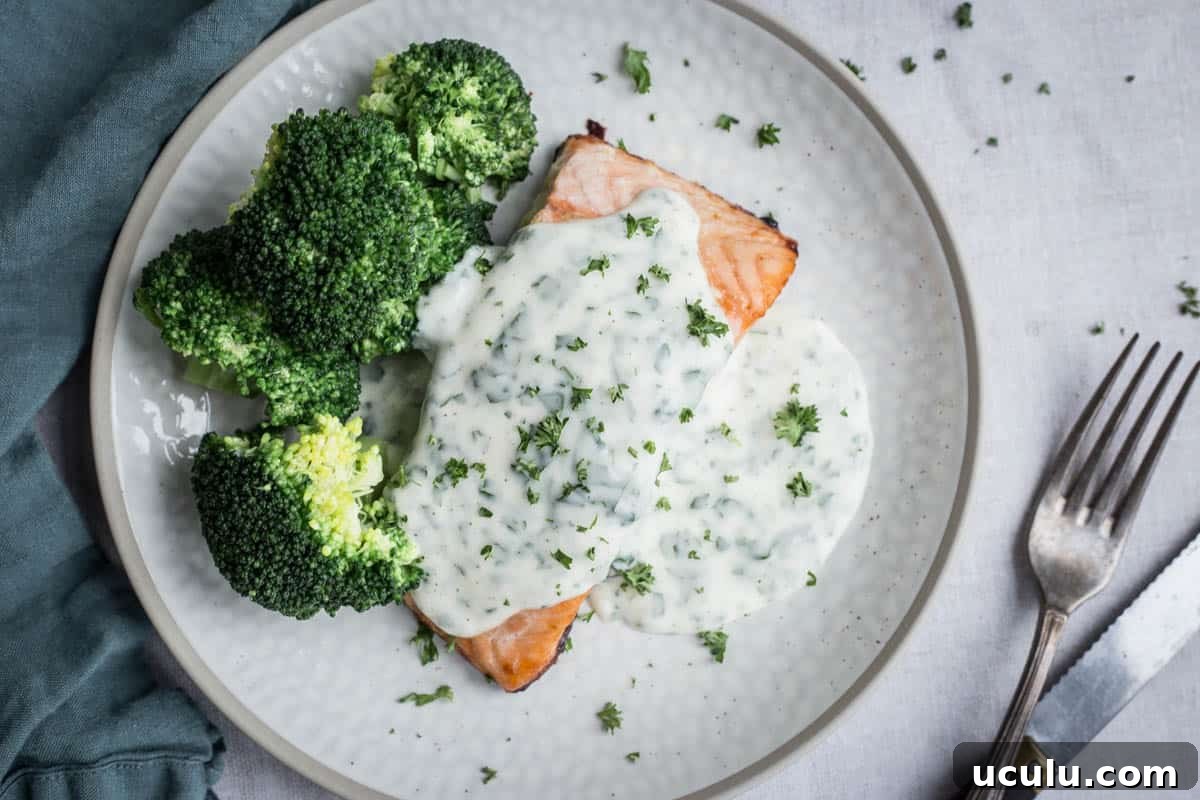 Parsley sauce drizzled over salmon and broccoli on a plate