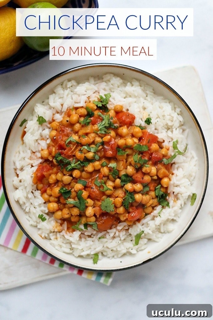 Chickpea curry served with white rice and garnished with chopped coriander.