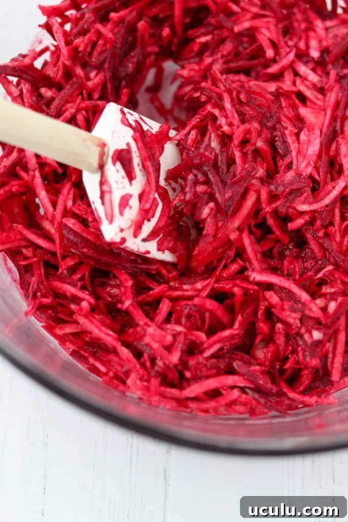 A close up of shredded beets and a spatula