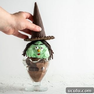 hand placing hat on top of Halloween witch ice cream sundae