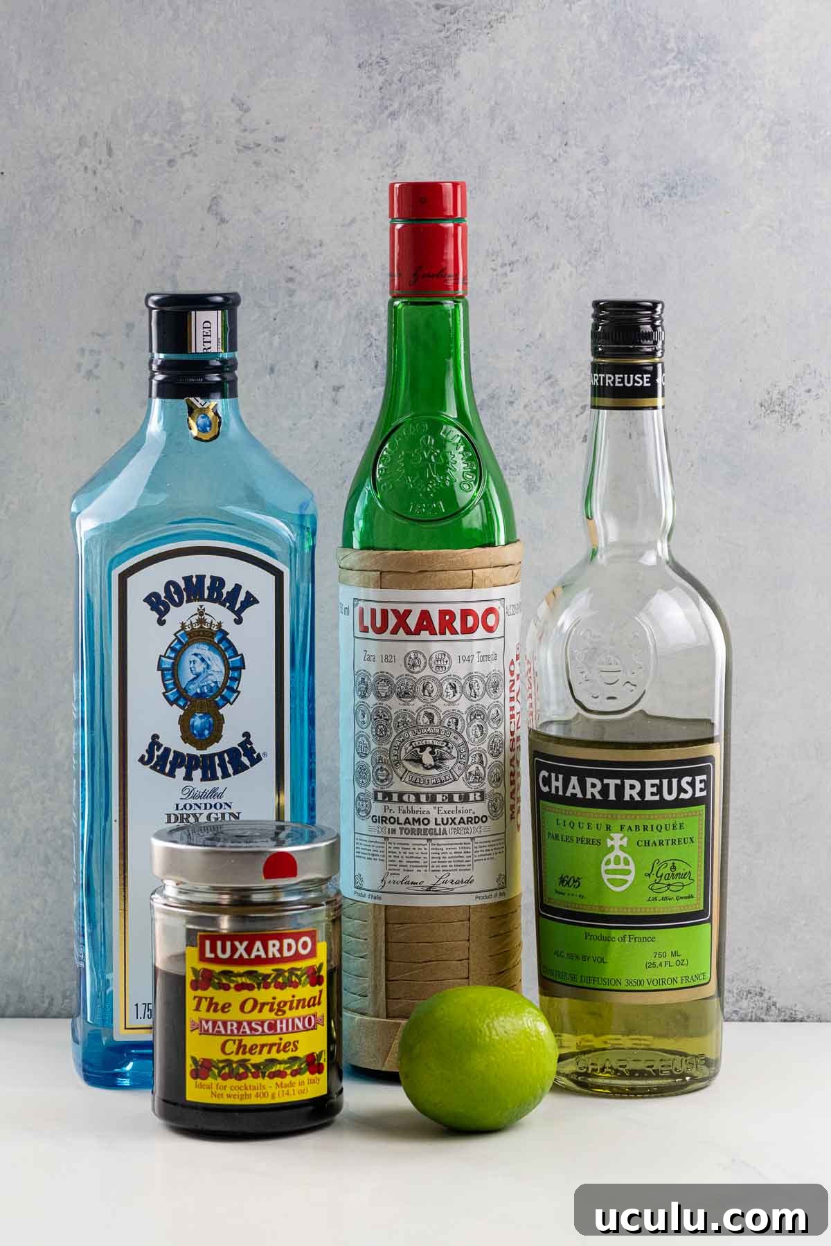 Ingredients for The Last Word cocktail: Gin, Luxardo, Green Chartreuse, a lime, and Luxardo cherries