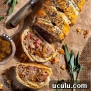 Sausage plait with two slices sliced from it on a sheet of brown paper.
