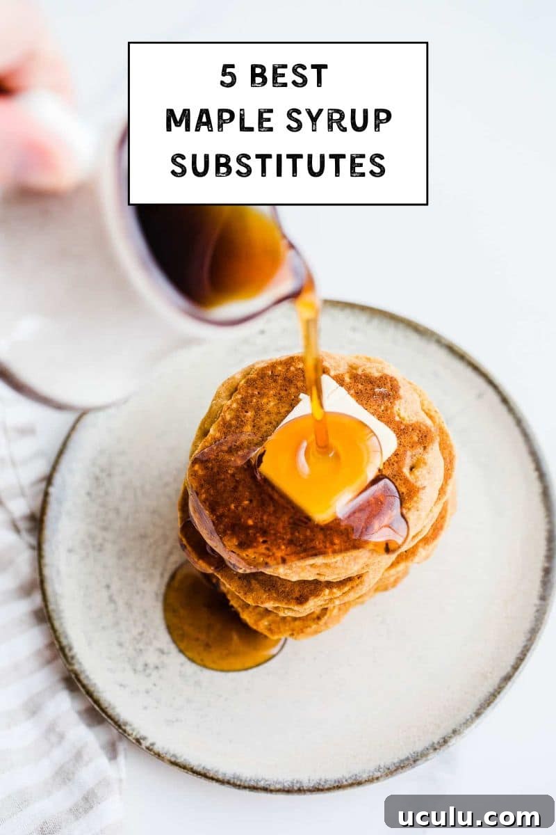 A plate of pancakes with syrup being poured on top.