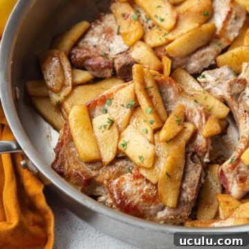 pork chops and apples in a skillet.