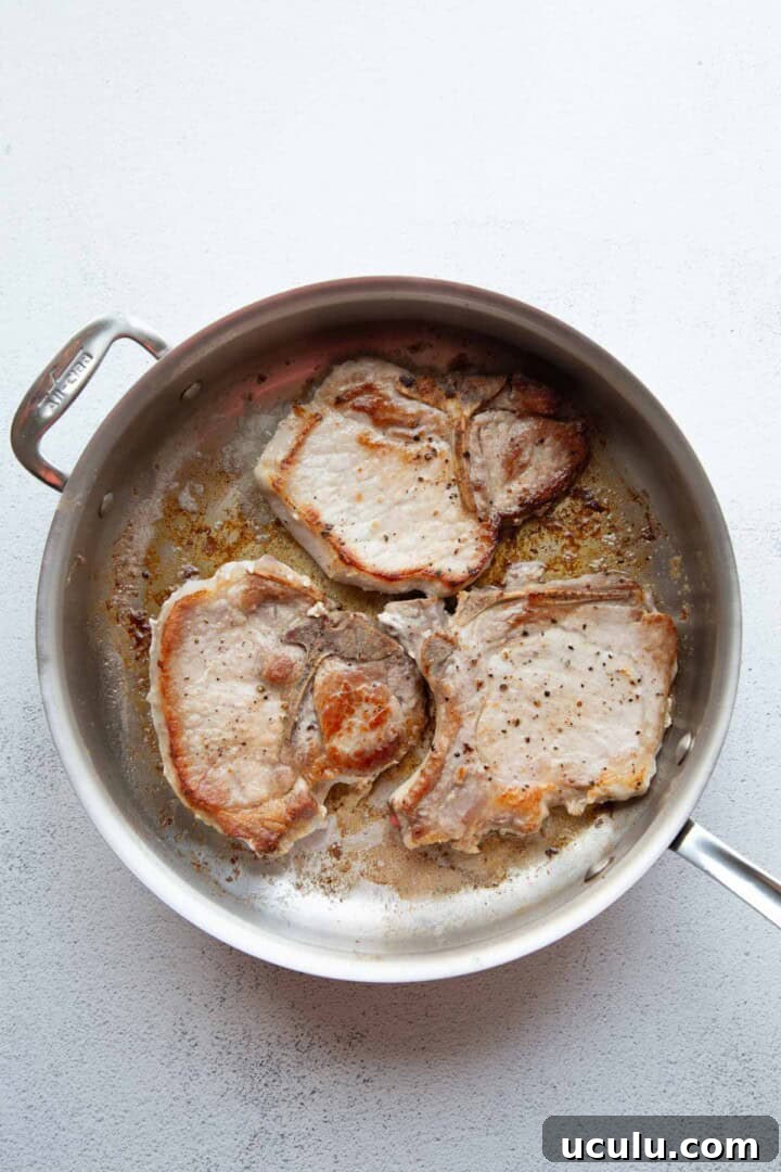 cooked pork chops in a skillet.