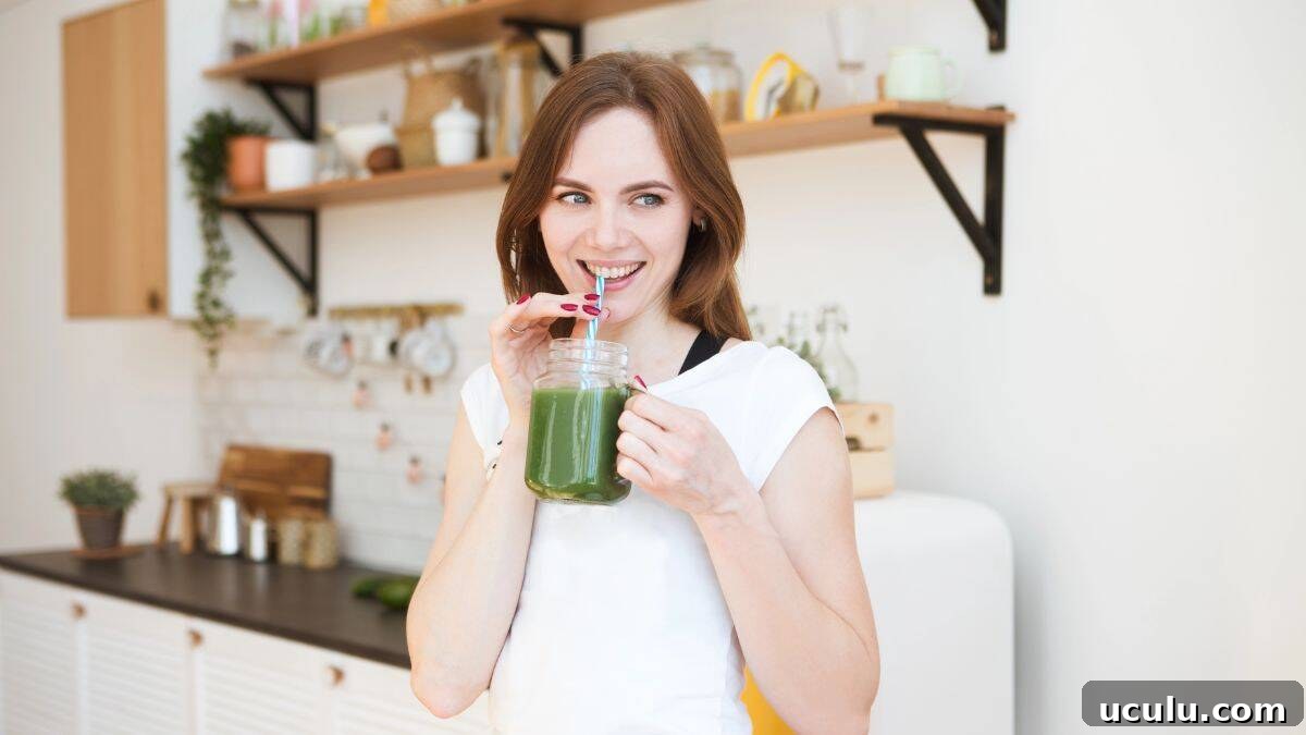 woman drinking green smoothie