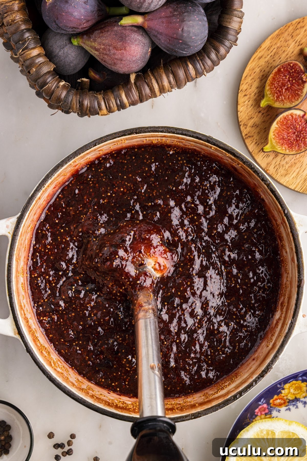 Immersion blender breaking larger chunks of figs in the balsamic fig jam mixture.