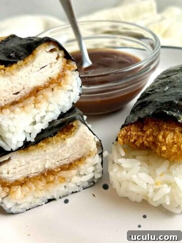 side view of sliced chicken katsu musubi on plate