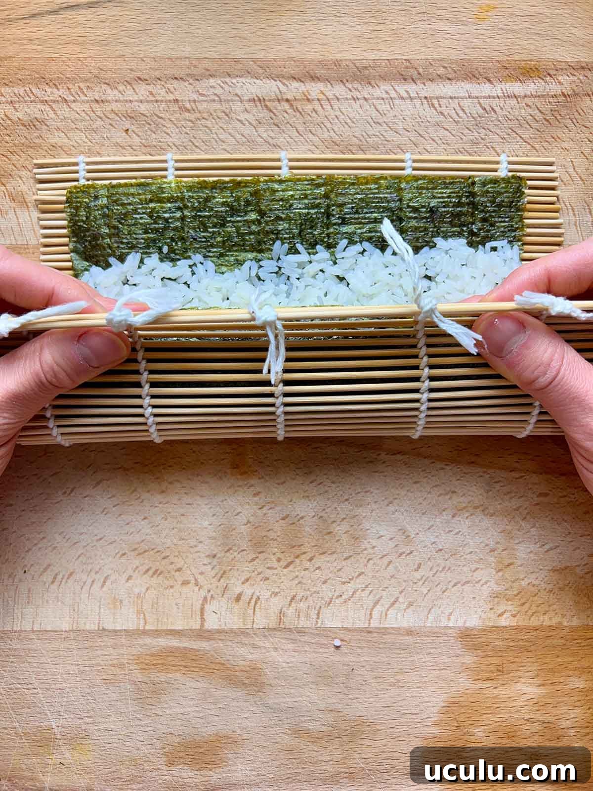 rolling kimbap in bamboo mat