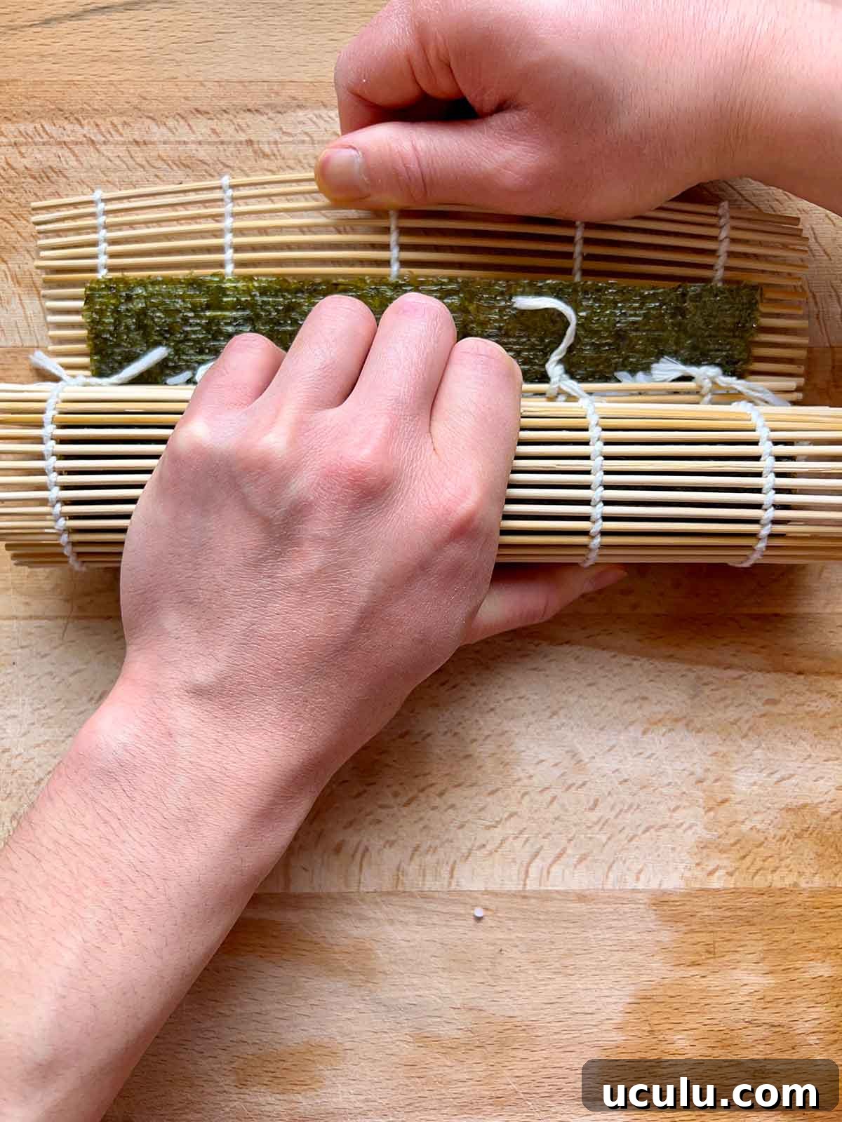 rolling tuna kimbap, pulling the bamboo mat