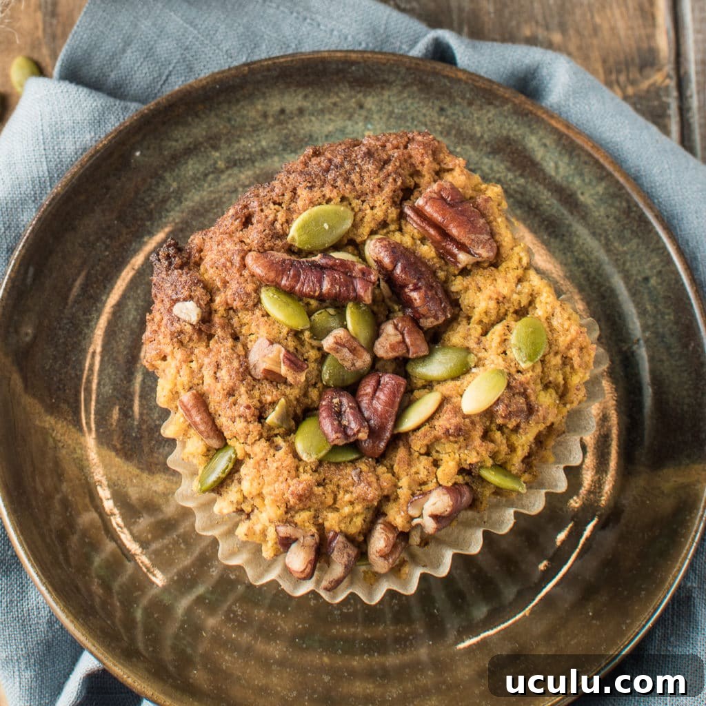 A lone pumpkin muffin on a plate.