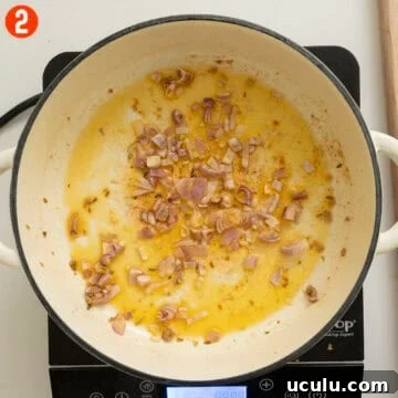 Sauteing shallots in a pan.
