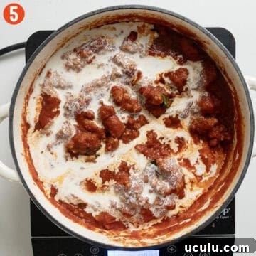 Adding heavy cream to the sauce.