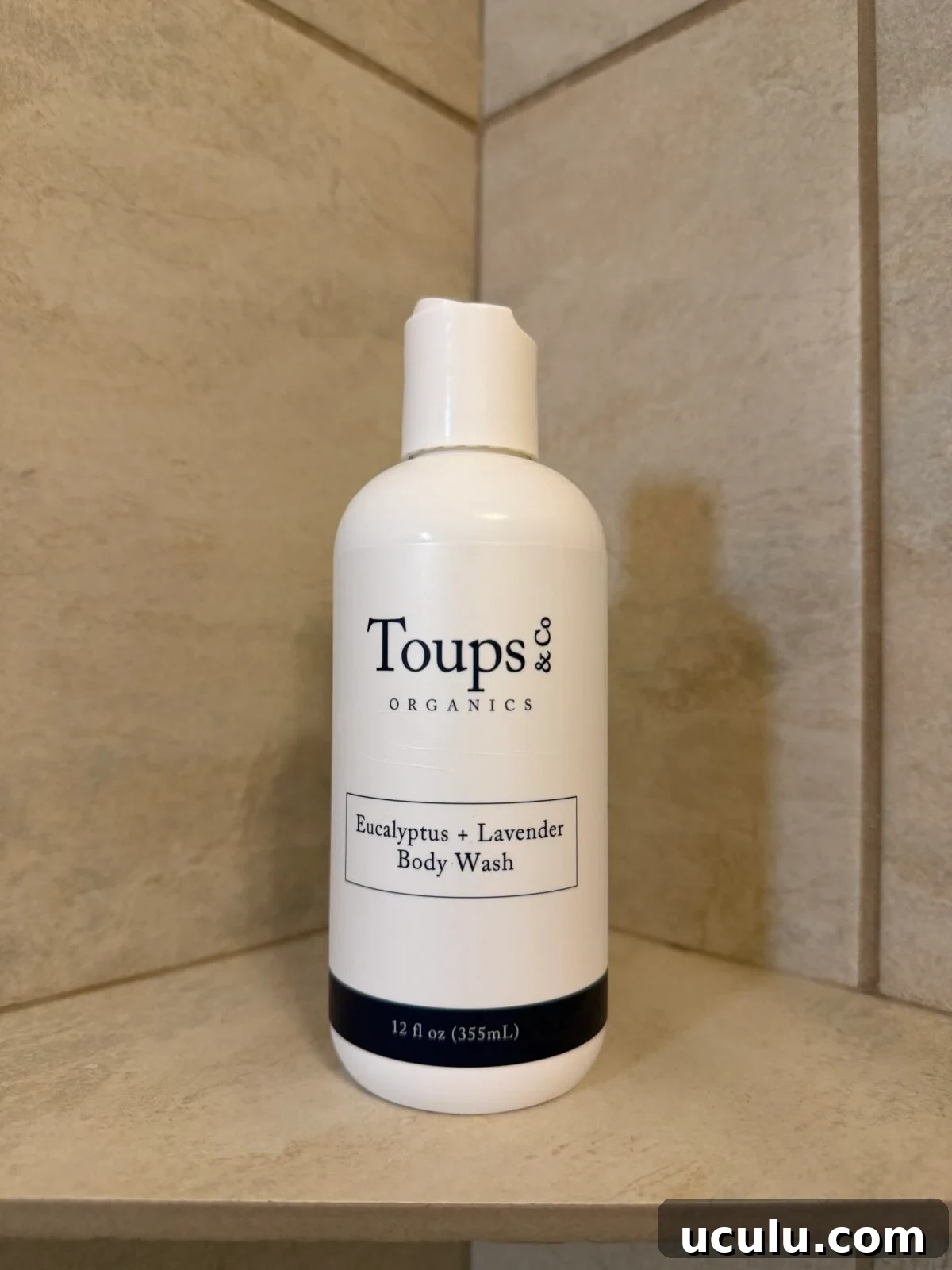 Toups & Co Organics Eucalyptus + Lavender Body Wash bottle on a tiled shower shelf