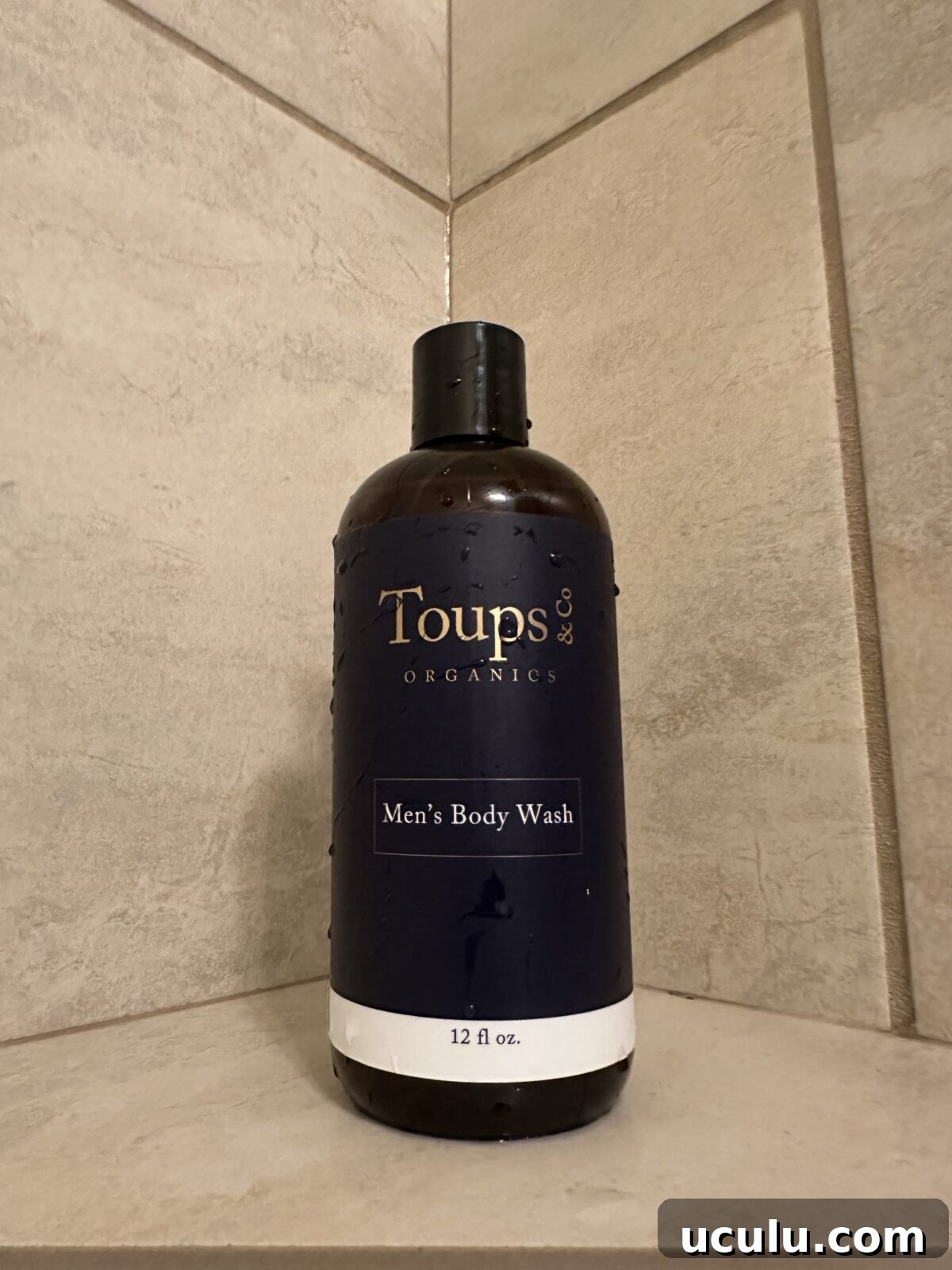 Toups & Co Organics Men’s Body Wash bottle on a tiled shower shelf