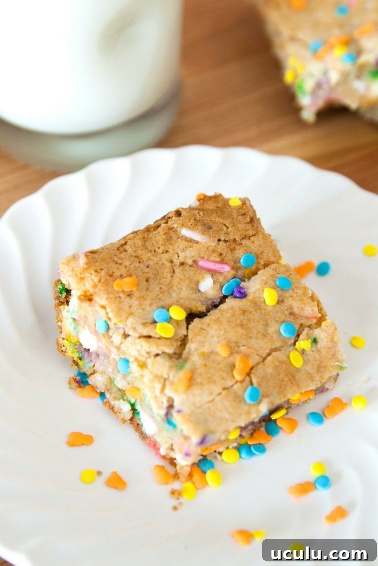 Cake Batter Blondies on a serving plate with colorful sprinkles