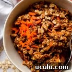 carrot cake baked oatmeal in a bowl with a spoon