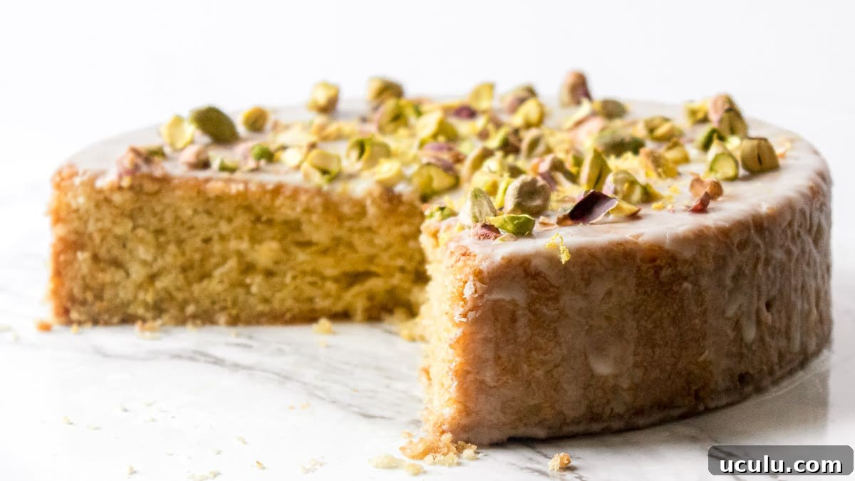 vegan olive oil cake on a platter with a slice cut out