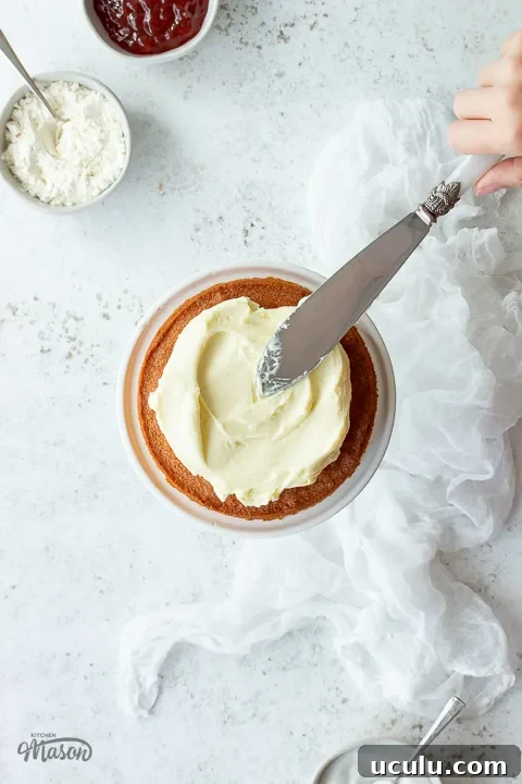 Icing being smoothed over a cake