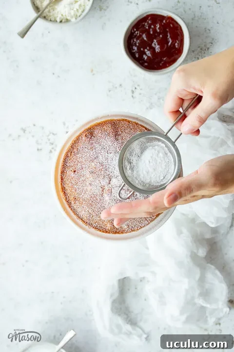 Icing sugar being dusted over a cake