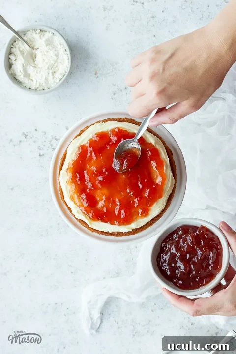 Jam being spread on a cake