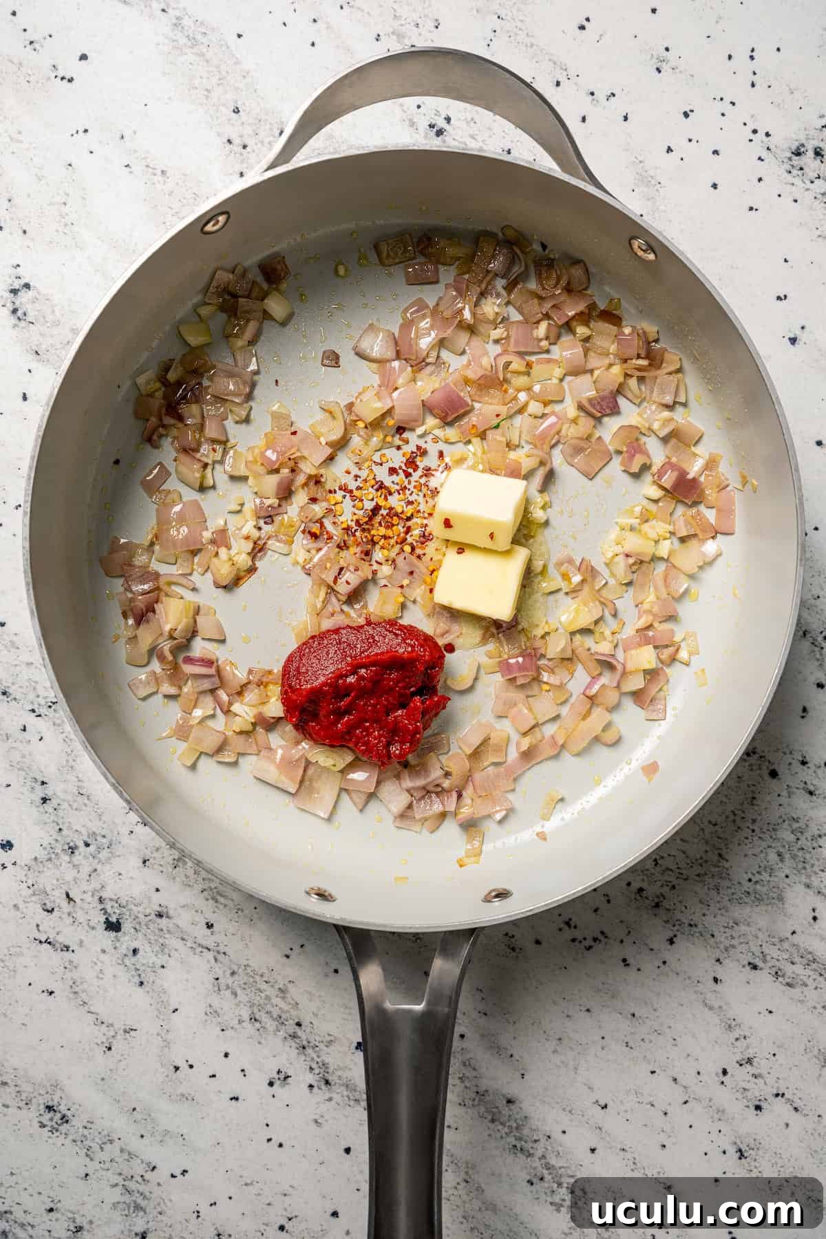 Sauteed onions, butter, and tomato paste in a large skillet.