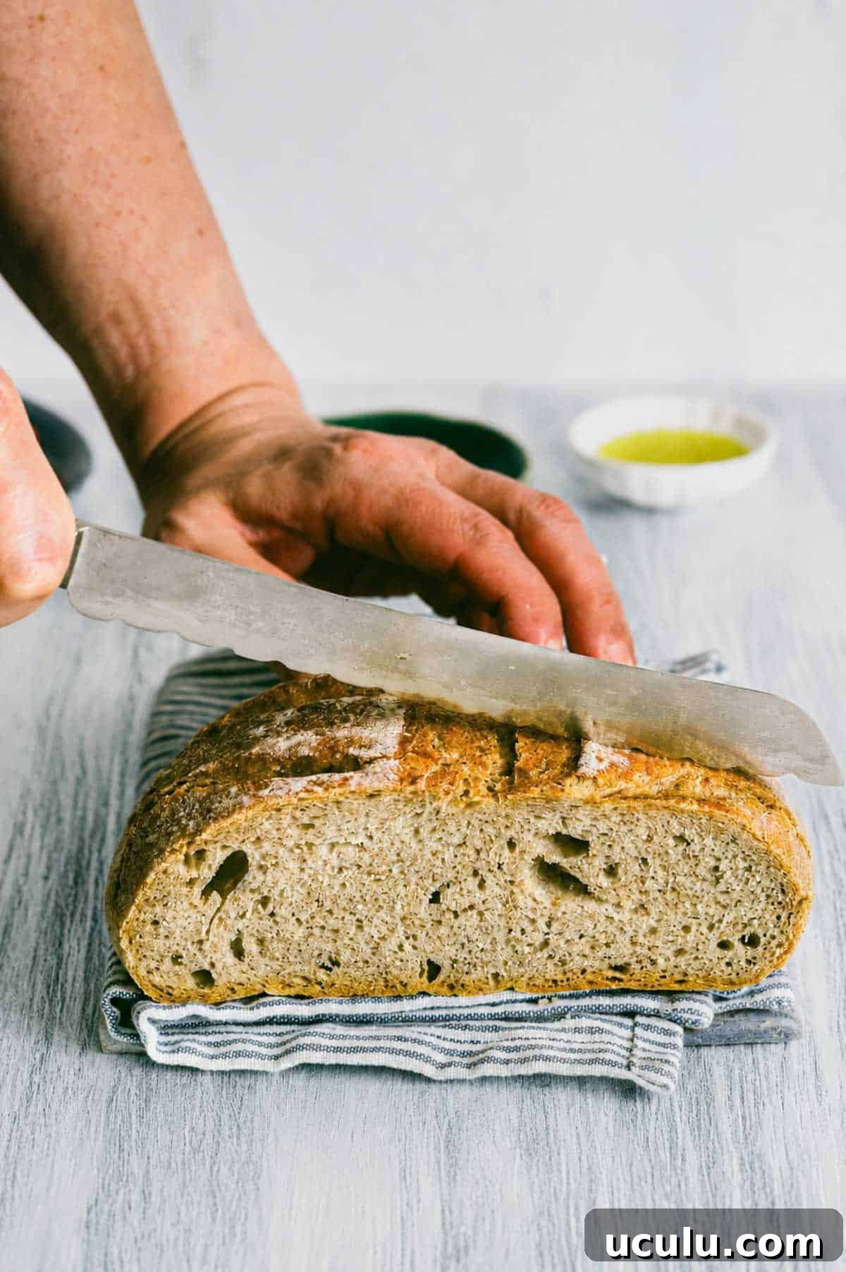sourdough bread being sliced.
