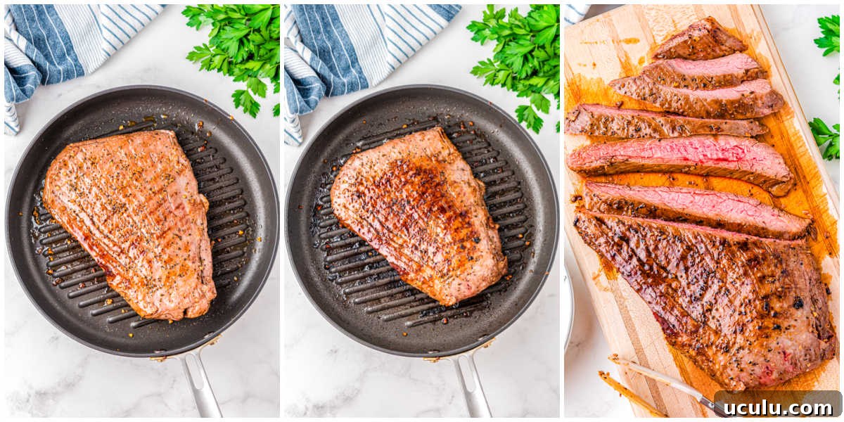 A marinated flank steak cooking in a cast iron pan and then cut into slices.