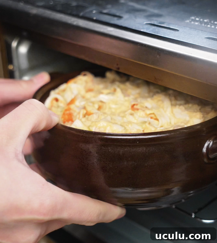 The assembled sushi bake is placed into the oven to broil until bubbly and golden brown.