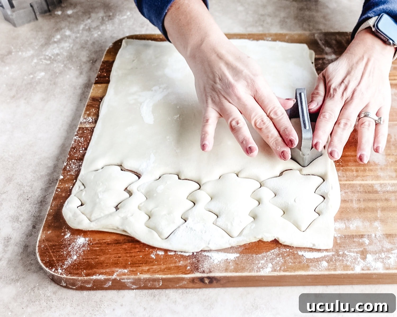 Use a Christmas tree cookie cutter to cut out shapes from the puff pastry.