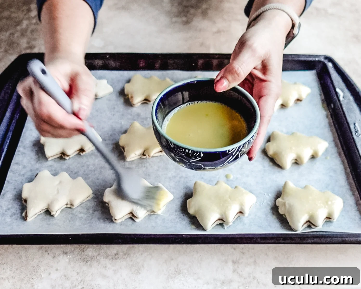 Brush tops of the Christmas tree cut-outs with egg wash before baking.