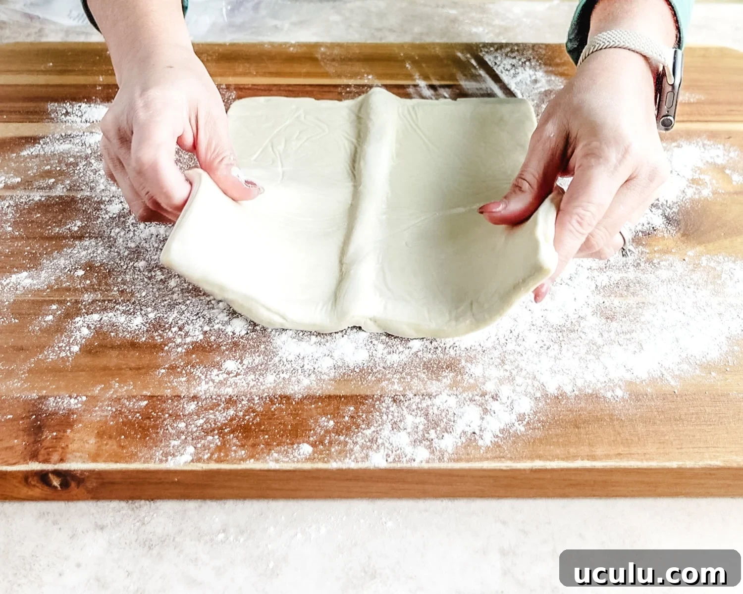 Place thawed puff pastry on the floured work surface.