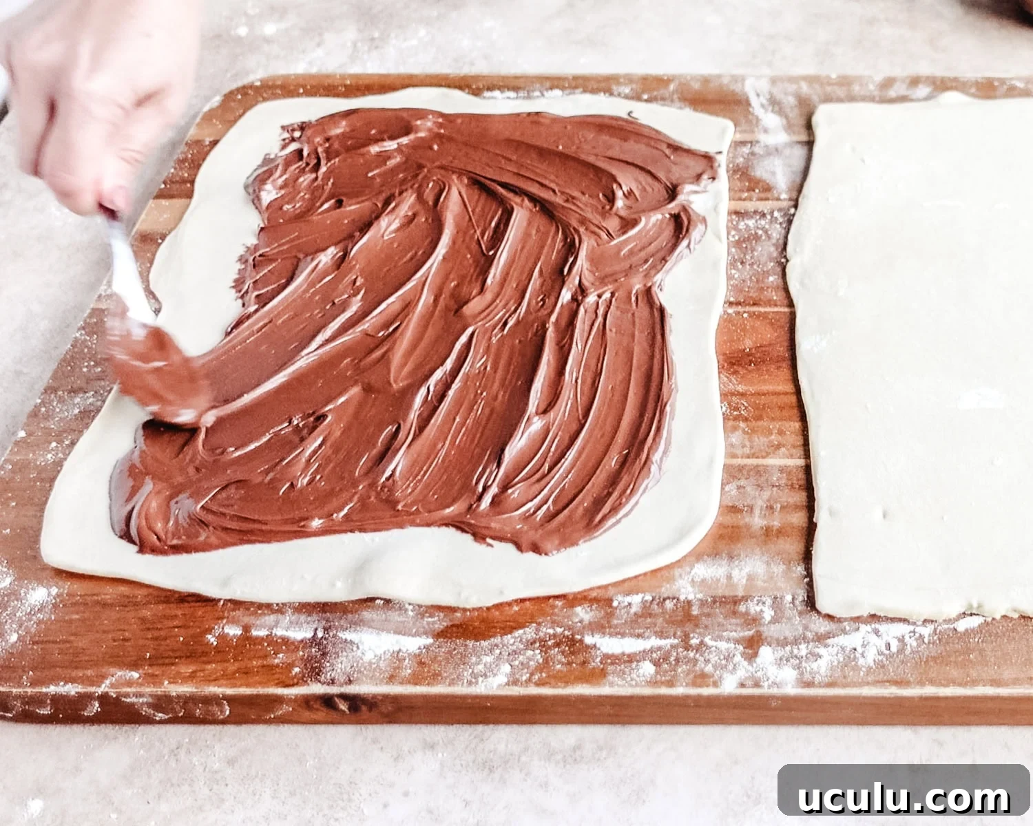 Spread Nutella into a thin layer almost to the edges.