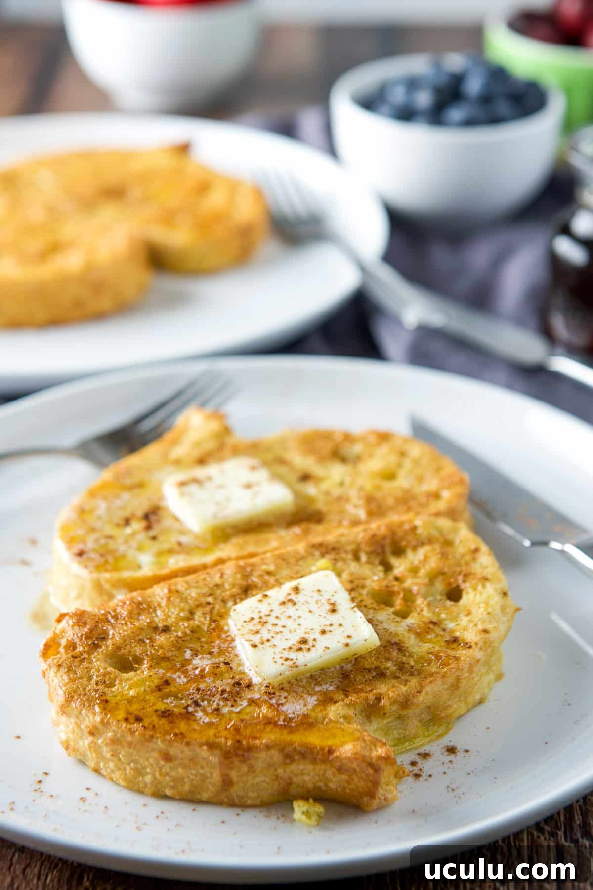 Butter, and cinnamon on the French toast with fruit in the back