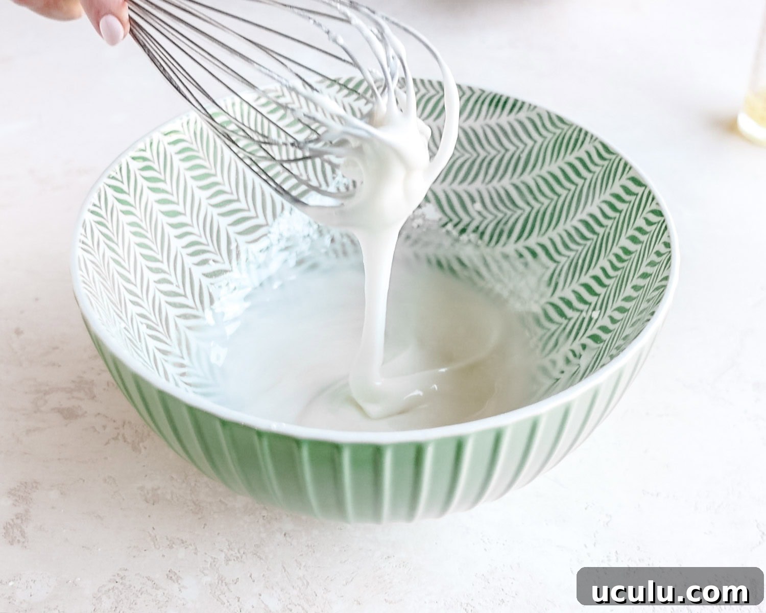 Glaze should be thick and run easily off the end of the whisk.